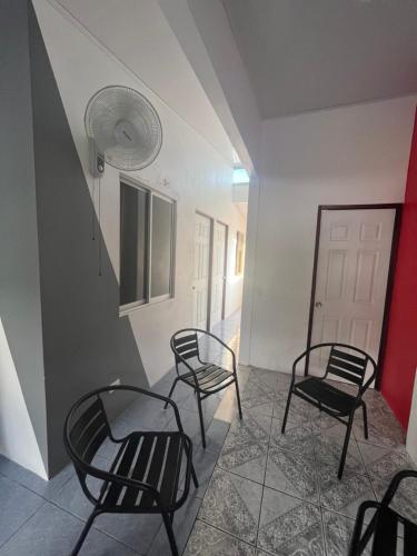 a group of chairs in a room with a staircase at Buganvilla No 3 in Quepos