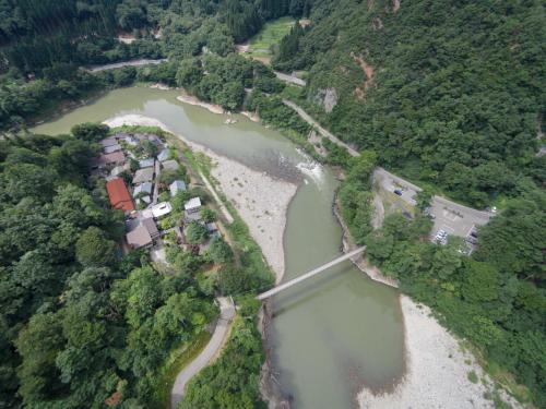an aerial view of a river with a bridge at Takanosukan in Sekikawa