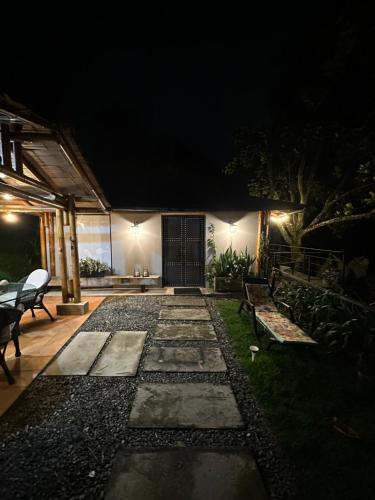 a backyard at night with a stone pathway at Loft bambu in Envigado