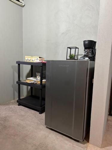 a small refrigerator and a shelf in a room at Loft bambu in Envigado