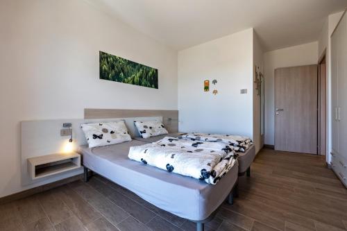 a bedroom with a large bed in a room at Agriturismo Bocca Nevese Abete in Tremosine Sul Garda