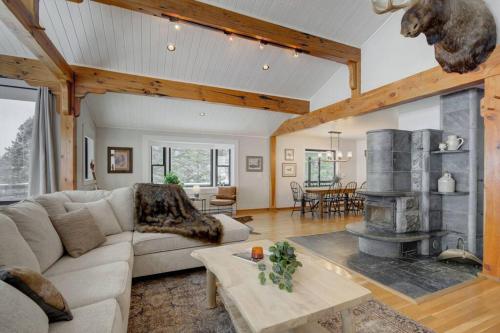 a living room with a couch and a fireplace at Quinn Peaks Retreat House in Bozeman