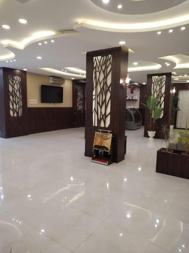 a lobby with a fireplace and a television in a building at شقق هدوء الليالي للشقق المخدومة in Khamis Mushayt