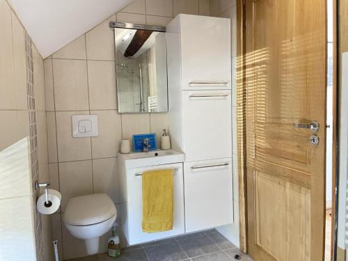 a bathroom with a toilet and a yellow towel at Cottage - The Moulin Treillard - Sleeps3 - Parking in Saint-Hilaire-La-Treille