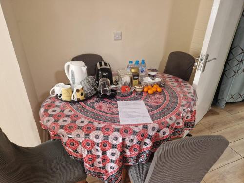 a table with a table cloth on top of it at Beautiful 1-Bed studio Lickey Hills Birmingham in Birmingham