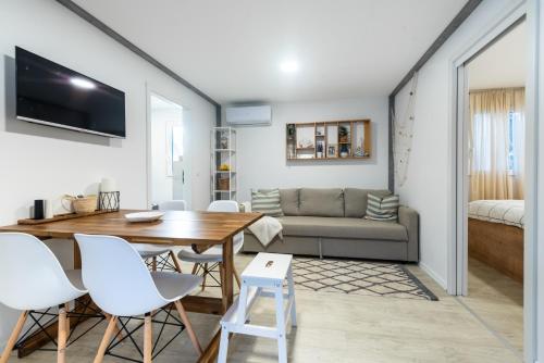 a living room with a table and chairs and a couch at Tiny home Rubi in Oaza Mira resort in Drage