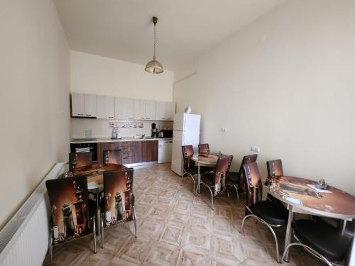 a kitchen and dining room with a table and chairs at Antique ApartHotel in Alba Iulia