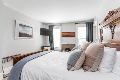a bedroom with a large white bed with pillows at Col Robert Van Horn at Southmoreland on the Plaza in Kansas City