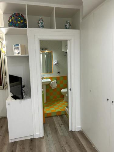 a bathroom with a toilet and a television in it at MH Design Hotel in Naples