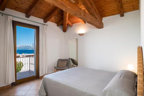 una camera con un letto e una grande finestra di Bellosguardo 3, 8 - Klodge a Olbia