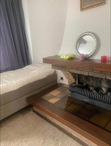 a room with a bed and a mirror on a table at Private room in the centre of Tilburg in Tilburg
