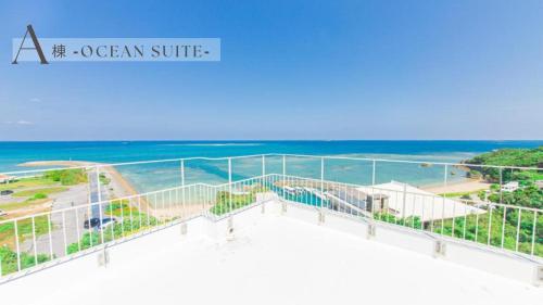 a view of the beach from the balcony of a ocean surfominium at クリスタルヴィラ南城 in Azama