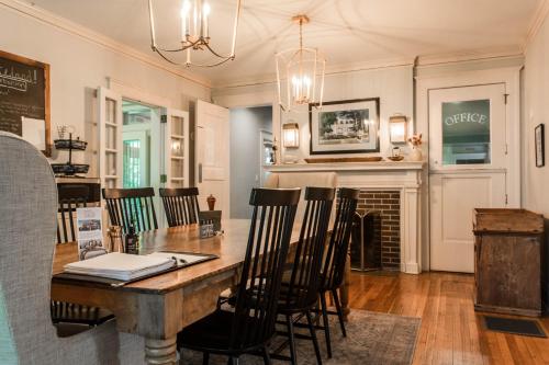 a dining room with a table and chairs and a fireplace at Ella and Jacob Loose at Southmoreland on the Plaza in Kansas City