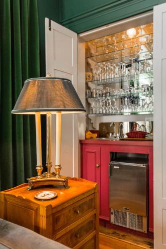 a lamp on top of a wooden table in a kitchen at Ella and Jacob Loose at Southmoreland on the Plaza in Kansas City