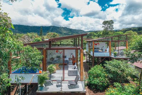 a glass house with a view of the mountains at Coffee Lodge Cristal Glamping & Spa in Mindo
