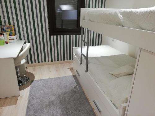 a room with two bunk beds and a sink at A CASIÑA DA EIRAVELLA in Hio