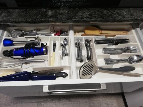 a drawer full of kitchen utensils on a shelf at A CASIÑA DA EIRAVELLA in Hio