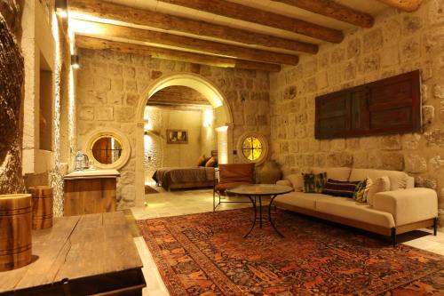 a living room with a couch and a table at Cappadocia Vita Cave Hotel in Urgup