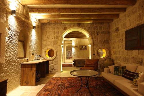 a living room with a couch and a table at Cappadocia Vita Cave Hotel in Urgup