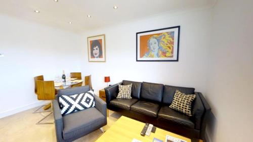 a living room with a couch and a chair at Signet Apartments - Coronation House in Cambridge