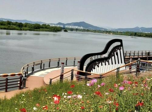 a large harpsichord sitting on the side of a river at Hosandong House in Daegu