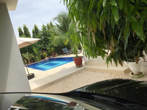 a car parked in front of a swimming pool at Villa chez ibou somone in Somone