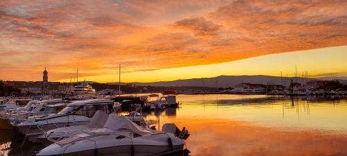 a group of boats docked in a marina at sunset at Apartment Denis in Krk