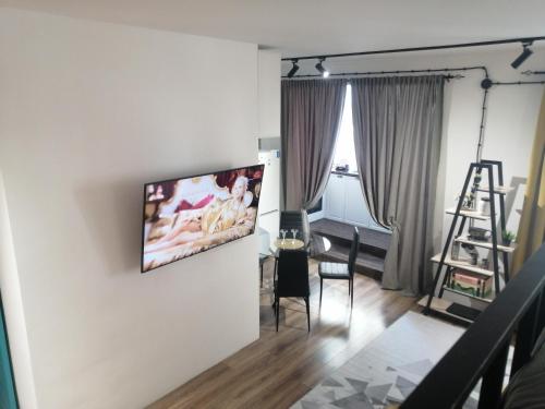 a living room with a flat screen tv on the wall at Квартира посуточно in Aktau