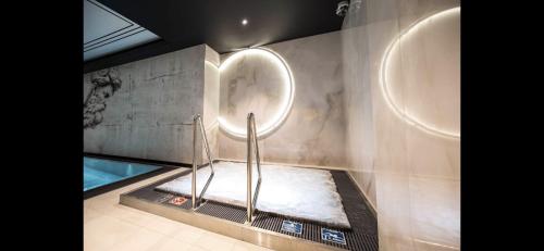 a bathroom with two urinals and a sink at Deo Plaza by Blue Mandarin in Gdańsk