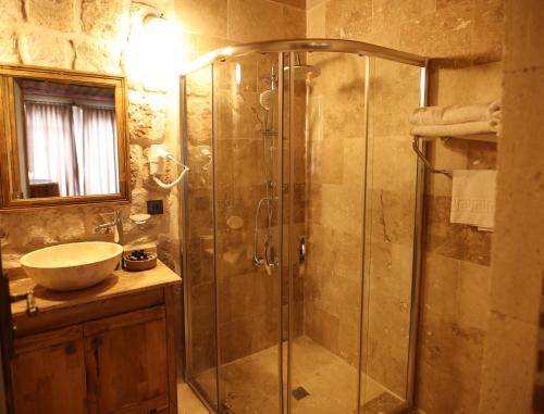a bathroom with a shower and a sink at Vita Cave Suites in Urgup