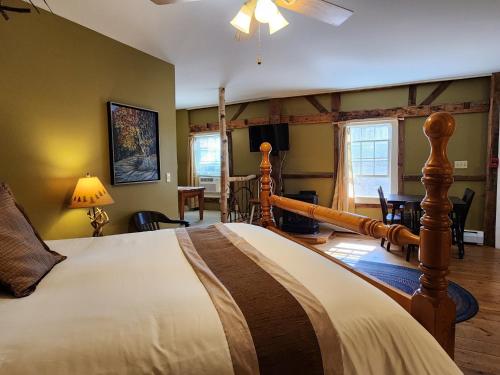 a bedroom with a bed and a living room at Blackberry Inn in Camden