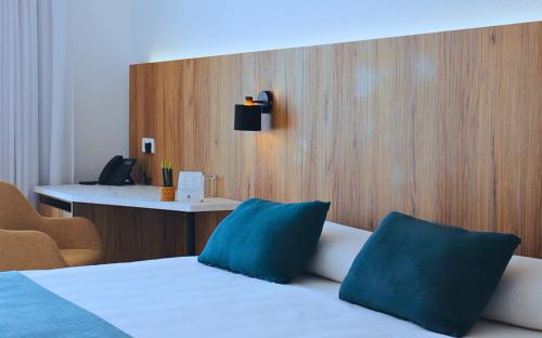 Una cama o camas en una habitación de Alfons Hotel