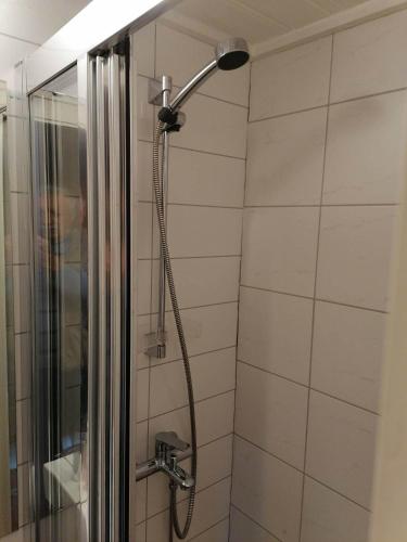 a shower with a shower head in a bathroom at Sognevegen 2242 in Haugsvær