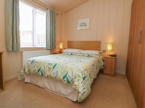 a bedroom with a large bed and a window at Ocean Terrace 1 in Ilfracombe
