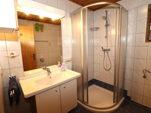 a bathroom with a shower and a sink and a shower at Pargger in Grün