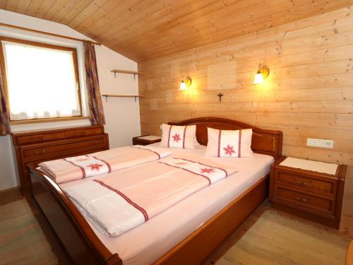 a bedroom with a large bed in a wooden room at Pargger in Grün