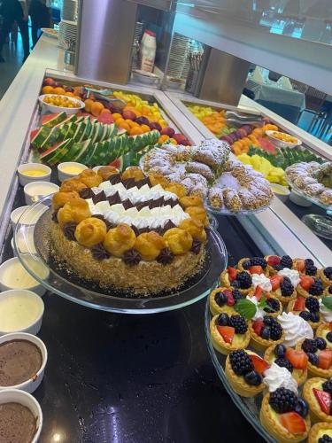 a buffet filled with different types of food on display at Hotel Daniel's FRONTE MARE in Riccione