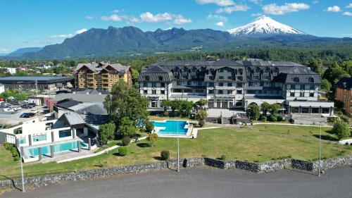 an aerial view of a resort with a mountain in the background at Hotel Enjoy Pucon in Pucón