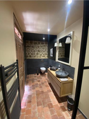 une salle de bain avec un lavabo et des toilettes dans l'établissement Domaine Des Tours Vauquelin, à La Fresnaye-au-Sauvage