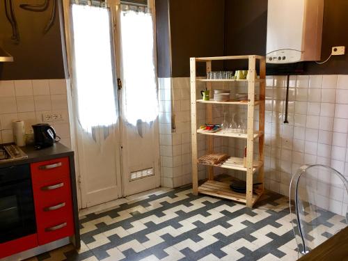 a kitchen with a book shelf next to a door at AwesHomeItaly - Bay Windows Apartment in La Spezia