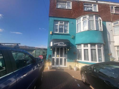 a blue house with a car parked in front of it at The Rosslyn in Paignton