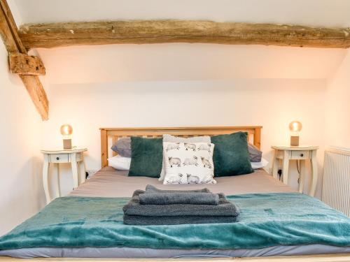 a bedroom with a bed with towels on it at The Barn in Llangwm