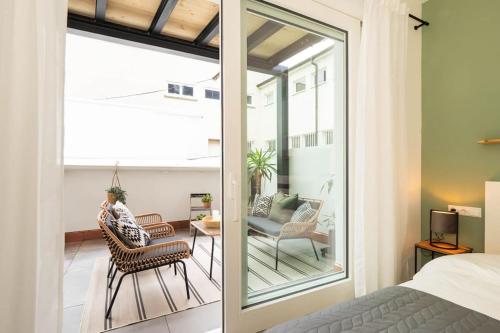 a bedroom with a balcony with a bed and chairs at Luxury Apartment, in the Old Town on the Lake... in Überlingen