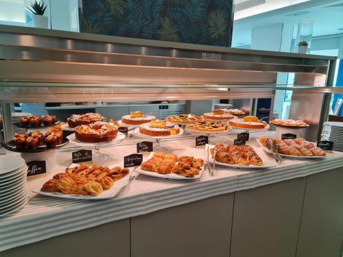 a buffet line with many different types of pastries at Hotel Daniel's FRONTE MARE in Riccione
