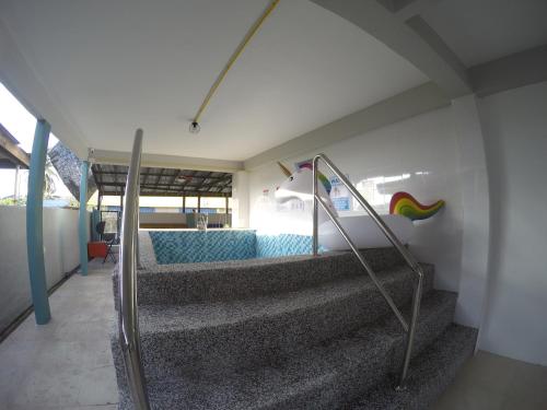 a set of stairs in a room with a pool at CoCo Fun House Kemaman with Pool and Bathtub in Kampong Gong Pauh