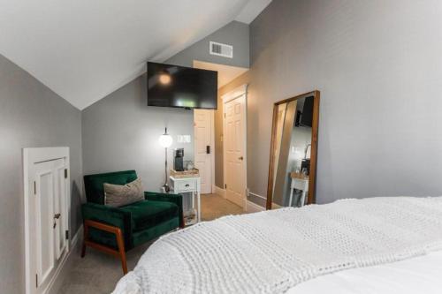1 dormitorio con 1 cama blanca y 1 silla verde en William Gillis at Southmoreland on the Plaza en Kansas City