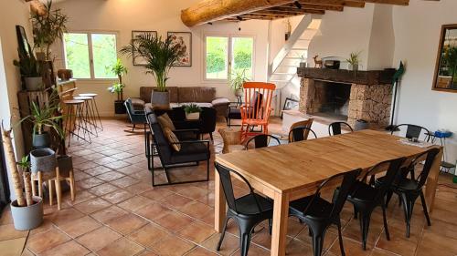 a living room with a table and a fireplace at Villa Martinus in Saint Paul de Vence