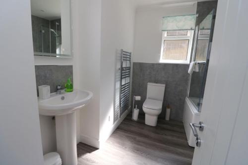 a white bathroom with a sink and a toilet at Borve House, Kilchoan in Kilchoan