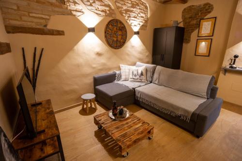 a living room with a couch and a coffee table at Appartamenti le Scalette G e D in Osimo