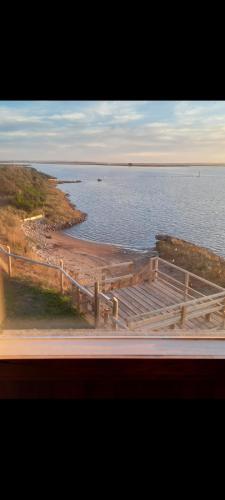 a view of a body of water with a wooden fence at Portal de la Patagonia Austral in Puerto Montt